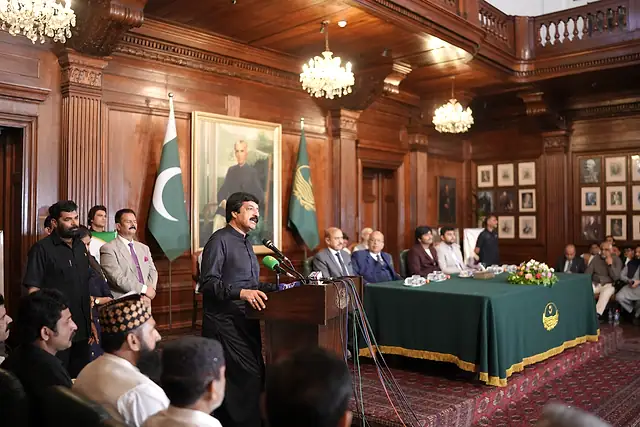 The Governor of Punjab addresses the NSDP ceremony from the podium at Governor House Lahore