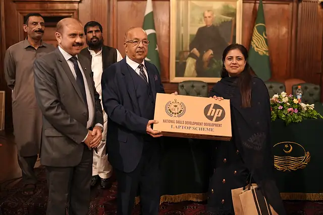 Major General Zawar Hussain Shah (Retd) presents a laptop box to a student
