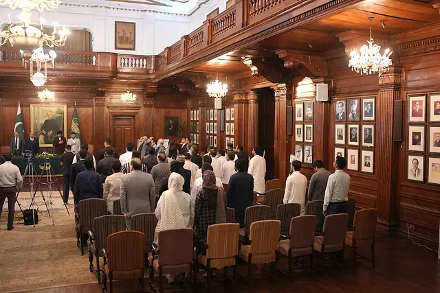 Guests stand in the hall for the national anthem