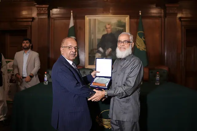 Major General Zawar Hussain Shah (Retd) presents a shield to a member of the Pakistan Engineering Council